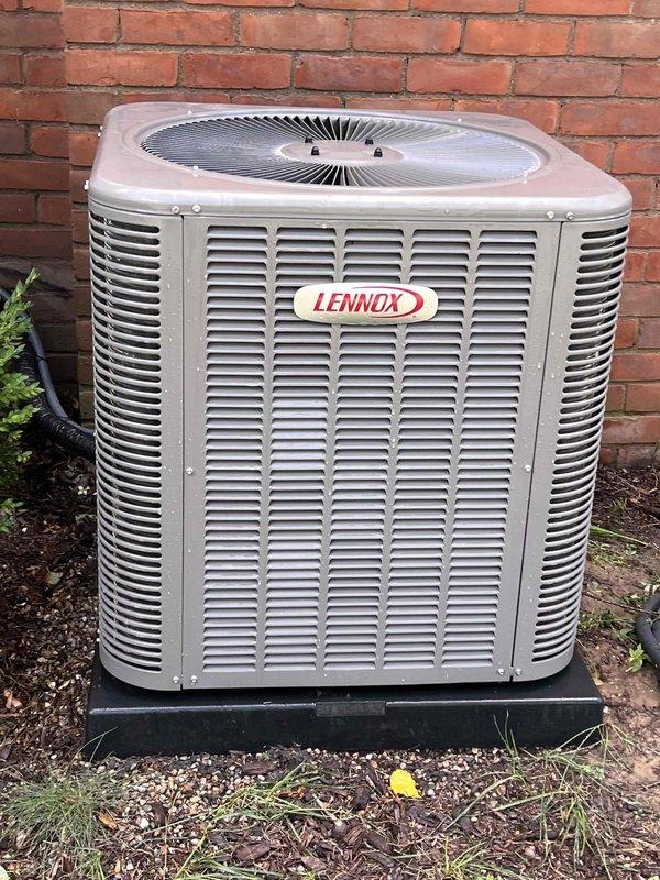 Completed Gold AC Inspection on a one-year-old Lennox air conditioning system with basement coil location. Performed comprehensive system diagnostics using digital manifold gauges, confirming proper R410A refrigerant charge with suction pressure at 121.1 PSIG (41.1°F) and discharge pressure at 237.6 PSIG (80.4°F). Measured superheat at 15.0°F and subcooling at 4.0°F, both within acceptable operating parameters. Inspected outdoor condenser unit positioned on composite pad against exterior wall, noting unit in good operational condition with proper clearance and level installation. System operating efficiently with no deficiencies identified during inspection.