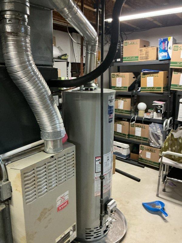 Responded to a water heater failure in a 22-year-old residential property where the existing unit had been leaking from the bottom for seven days. Removed and properly disposed of the failed water heater, then installed a new 40-gallon Bradford White tanked water heater in the basement mechanical room. Installation included connecting copper supply lines to the top of the unit, installing a drip pan beneath the water heater for leak protection, and ensuring all plumbing connections met code requirements. Verified proper operation of the new unit and confirmed no active leaks at supply connections or drain valve.
