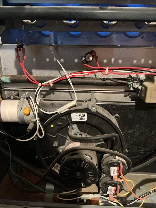 Completed comprehensive Gold-level preventative maintenance inspection on 6-year-old residential HVAC system consisting of furnace and air conditioning unit with evaporator coil located in basement. Performed combustion analysis using calibrated Testo 310 analyzer to verify proper burner operation, flue gas composition, and heat exchanger integrity. Conducted thorough visual inspection of all internal furnace components including blower motor assembly, pulley system, inducer motor, gas valve, ignition system, and electrical connections. Inspected and documented condition of wiring harnesses, noting proper routing of power leads and control wiring throughout cabinet. Verified blower motor operation and assessed overall cleanliness of blower housing and wheel. All components found operating within manufacturer specifications with no immediate safety concerns identified.