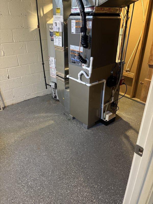 Successfully completed installation of 2-ton air conditioning system with evaporator coil and 40-gallon standard water heater in rear utility room. All refrigerant lines, condensate drainage, and electrical connections were properly installed and tested. Mechanical and electrical permits were obtained prior to installation, and existing thermostat was upgraded to Sensi programmable unit. System was commissioned, verified for proper operation, and customer qualified for available utility rebates from Consumers Energy and DTE.