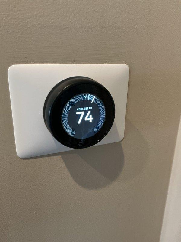 Completed comprehensive tune-up inspection on residential basement HVAC system including furnace and air conditioning unit of unknown age. Performed thorough system evaluation including thermostat functionality check (smart thermostat operating properly, set to cooling mode at 74°F), humidifier inspection, and hot water tank assessment (Bradford White Defender Safety System with Energy Star certification found in good operating condition). All components inspected, tested, and documented with photographic records; system operating within normal parameters with no immediate service requirements identified.