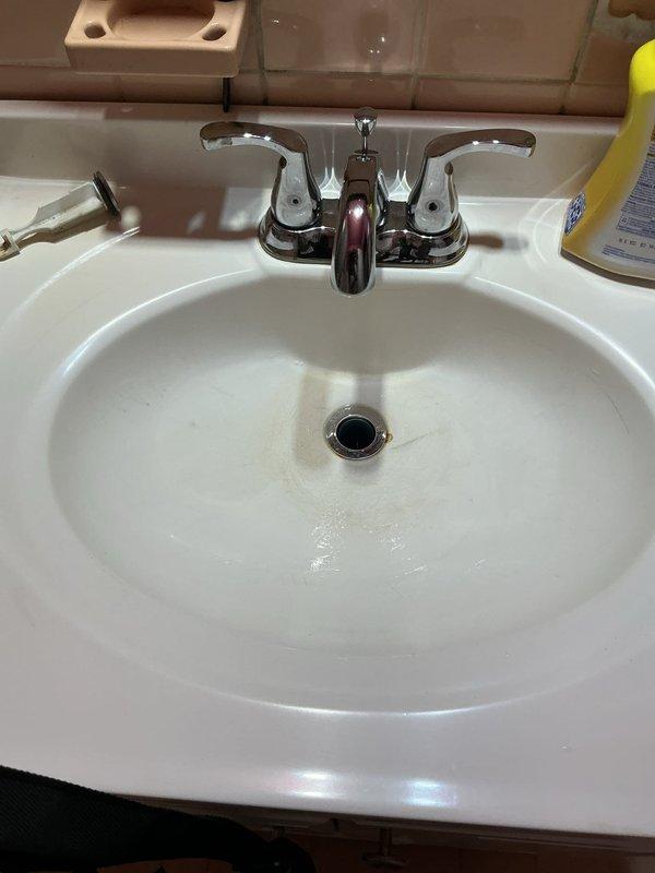 Responded to main floor bathroom sink drainage issue. Upon inspection, located and accessed main drain line through basement floor cleanout. Successfully cleared blockage in drainage system using appropriate equipment. Verified proper water flow and drainage at sink fixture upon completion, with all fixtures restored to normal operation.