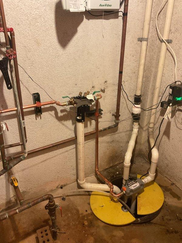 Installed a water-powered backup sump pump system alongside the existing primary pump to provide redundant protection against basement flooding. The installation includes new PVC discharge piping, check valves, and proper integration with the current copper supply lines and primary pump basin, ensuring automatic backup operation during power outages or primary pump failure.