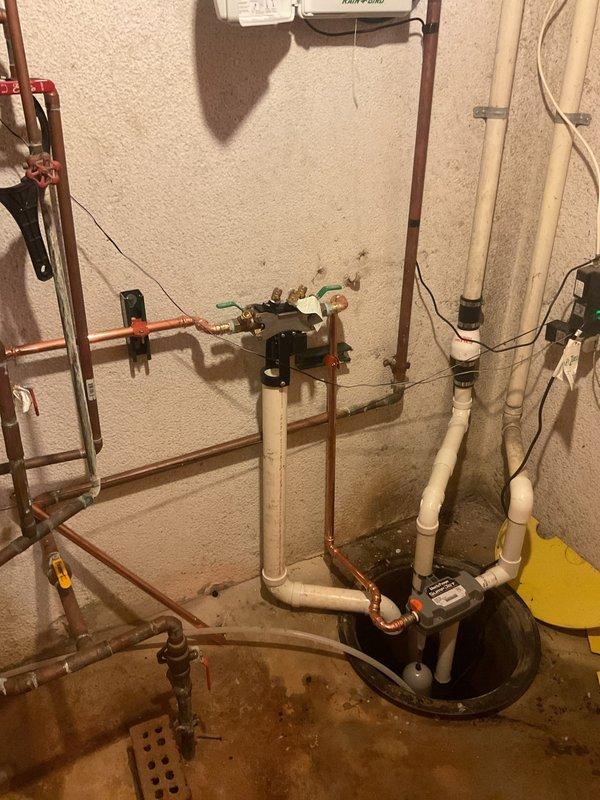 Installed a water-powered backup sump pump system alongside the existing primary pump to provide redundant protection against basement flooding. The installation includes new PVC discharge piping, check valves, and proper integration with the current copper supply lines and primary pump basin, ensuring automatic backup operation during power outages or primary pump failure.