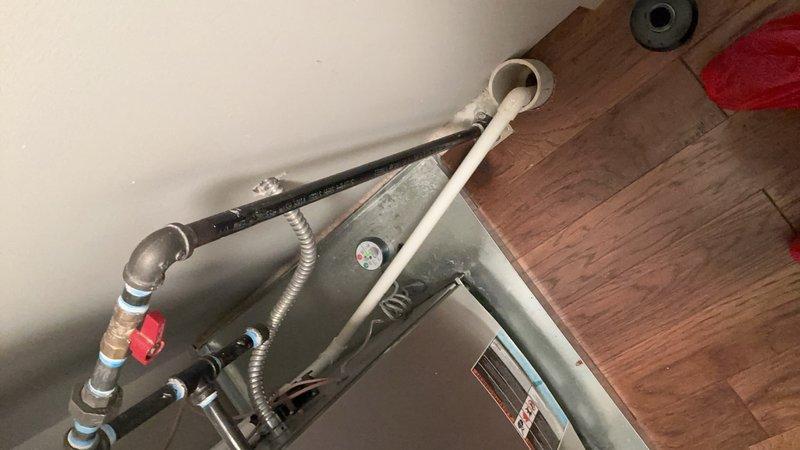 Responded to service call for clogged condensate drain line on second-floor air conditioning unit. Upon arrival, located HVAC system in utility closet alongside water heater and furnace equipment. Inspected condensate drainage system and confirmed blockage in PVC drain line preventing proper water discharge. Cleared obstruction from drain line using appropriate tools and techniques, restoring proper drainage flow. Verified system operation and confirmed unit was cooling effectively with condensate now draining freely through cleared line.
