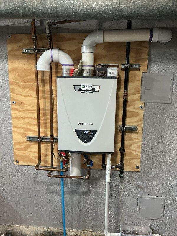 Responded to intermittent hot water loss and pressure fluctuation issues with AO Smith XE3 tankless water heater installed in 2022. Diagnosed surging sounds and pressure changes occurring when multiple fixtures operated simultaneously, particularly noticeable during shower use. Performed system inspection, flushed heat exchanger to remove mineral buildup, adjusted flow sensor calibration, and verified proper gas pressure and venting configuration. Tested unit under multi-fixture demand conditions to confirm consistent hot water delivery and stable pressure throughout the system. Unit now operating within manufacturer specifications with resolved intermittent failure and pressure surge issues.