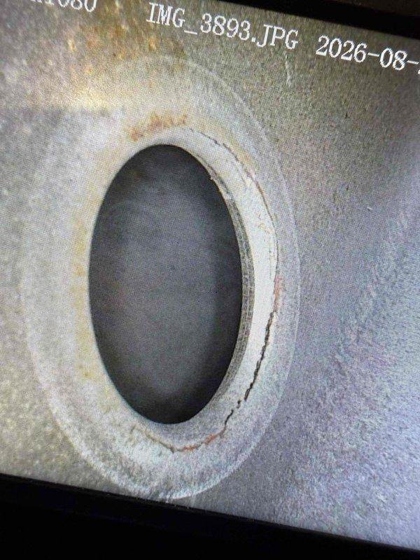 Responded to water leak complaint on 10-year-old air conditioning unit in basement. Upon inspection, discovered significant water staining and discoloration around the evaporator coil area, indicating prolonged moisture exposure. Found primary condensate drain line completely obstructed, causing water to back up and overflow into the living space. Observed corrosion and rust accumulation at the base of the air handler cabinet, consistent with chronic drainage issues. Cleared condensate drain blockage using appropriate tools and verified proper drainage flow. Flushed drain line with cleaning solution to remove biological buildup and debris. Inspected drain pan for cracks or damage; pan structurally sound but showed evidence of standing water. Tested system operation and confirmed condensate draining properly through primary drain line. Advised ongoing maintenance of condensate system to prevent future blockages. Photographed affected areas showing water damage to insulation and corrosio