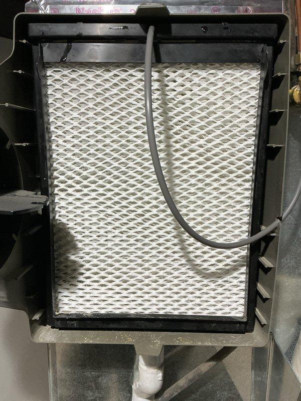 Performed comprehensive tune-up on 4-year-old HVAC system located in basement. Inspection included air filter evaluation, combustion analysis using Testo 310 analyzer (measured O2 at 7.5% and CO at 33 ppm), and system performance assessment. Additionally inspected humidifier, thermostat, and hot water tank as part of routine maintenance protocol.