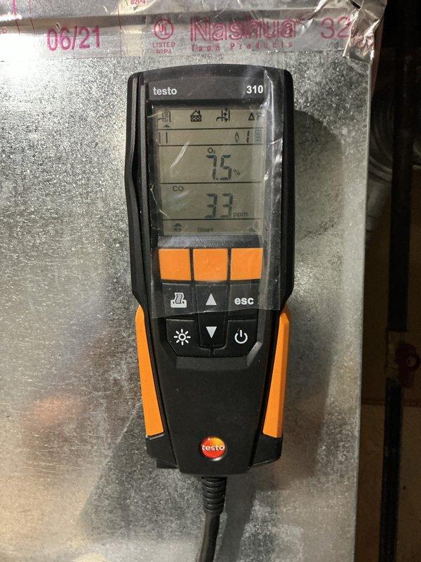 Performed comprehensive tune-up on 4-year-old HVAC system located in basement. Inspection included air filter evaluation, combustion analysis using Testo 310 analyzer (measured O2 at 7.5% and CO at 33 ppm), and system performance assessment. Additionally inspected humidifier, thermostat, and hot water tank as part of routine maintenance protocol.