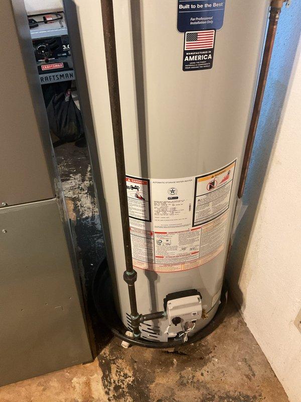 Addressed City of Warren plumbing code violation by installing a compliant metal overflow pad rated for gas water heater applications. Additionally replaced the water shut-off valve connected to the water heater outlet per customer request. All work completed to municipal code requirements with proper materials and installation standards.