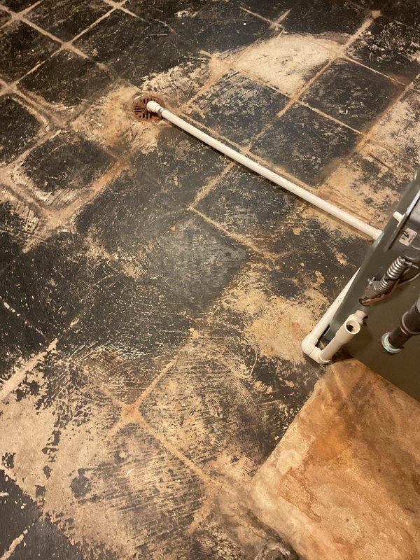 Addressed City of Warren plumbing code violation by installing a compliant metal overflow pad rated for gas water heater applications. Additionally replaced the water shut-off valve connected to the water heater outlet per customer request. All work completed to municipal code requirements with proper materials and installation standards.