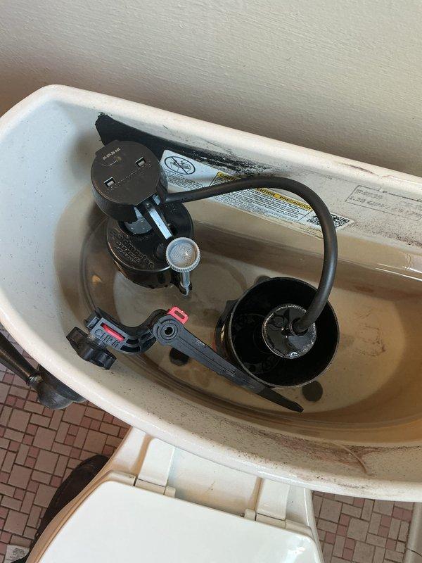 Responded to main floor bathroom plumbing issues in a sixty-year-old home where toilet was not filling properly after flushing. Inspected toilet tank components and identified fill valve malfunction preventing proper water refill. Examined fill valve assembly with red EASYSET cap, flush valve mechanism with rubber flapper, and overflow tube system. Verified water supply line and shut-off valve operation. Adjusted fill valve settings and tested flush cycle to restore proper tank refilling function. Also addressed bathtub diverter issue preventing proper switching from tub spout to shower head operation.