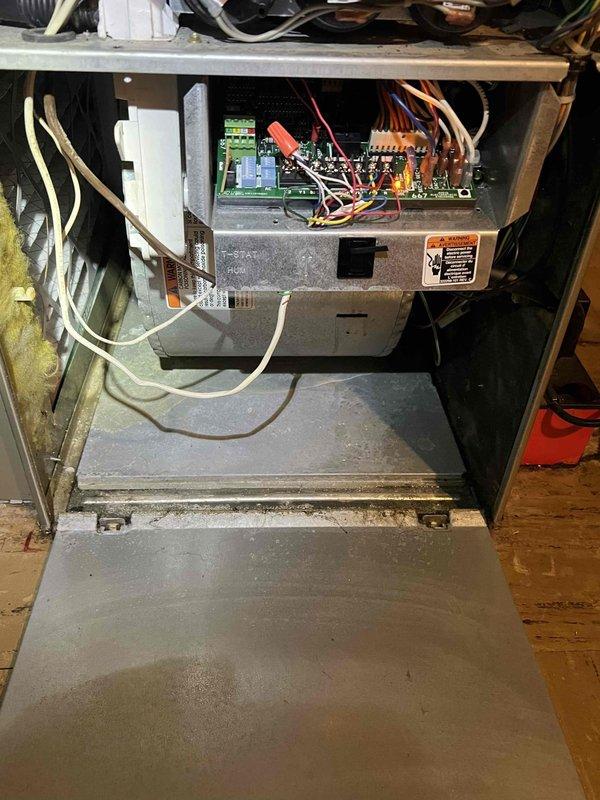 Responded to call for water leaking from furnace during air conditioning operation on a 10+ year old unit located in basement. Upon inspection, identified clogged condensate drain line causing water backup and overflow from the evaporator coil drain pan. Cleared blockage from condensate line using appropriate tools and verified proper drainage flow. Inspected evaporator coil assembly, drain pan, and associated components for damage or additional concerns. Tested system operation in cooling mode to confirm water is now draining properly through condensate line without leakage. Unit operating as designed with no further water discharge issues observed.