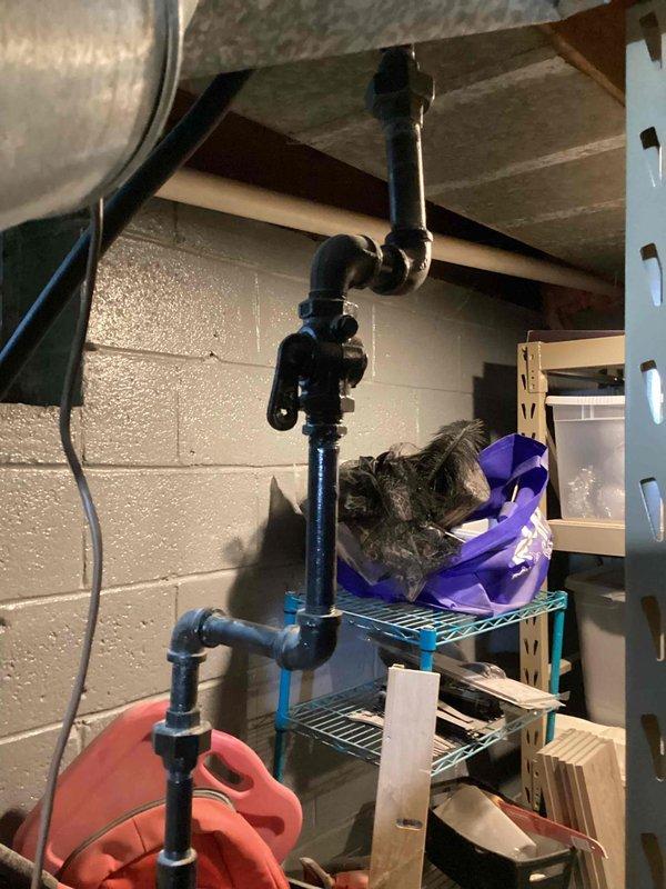 Conducted comprehensive full system evaluation for aging HVAC equipment replacement. Assessed existing outdoor air conditioning condenser unit positioned between building structures and inspected basement furnace installation with associated mechanical systems and ductwork. Documented current equipment conditions, spatial constraints, and existing infrastructure to provide accurate replacement system recommendations and quote preparation.