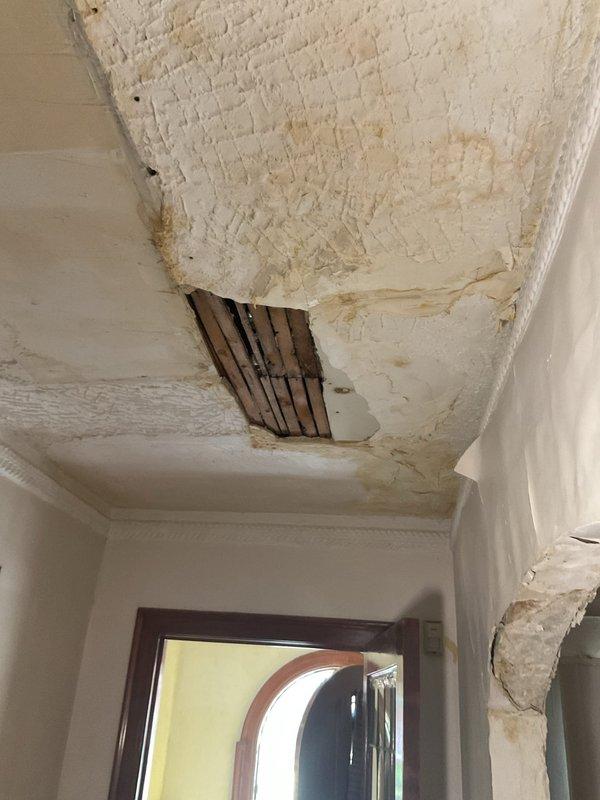 Responded to customer request for piping replacement assessment following extensive water damage to interior ceiling and walls. Upon inspection, discovered significant structural deterioration including exposed lath, peeling paint, brown water staining, and compromised plaster/drywall throughout the affected area, indicating prolonged moisture infiltration from failed plumbing above. Documented existing conditions and damage extent to provide accurate estimate for complete piping system remediation and subsequent ceiling repair work.