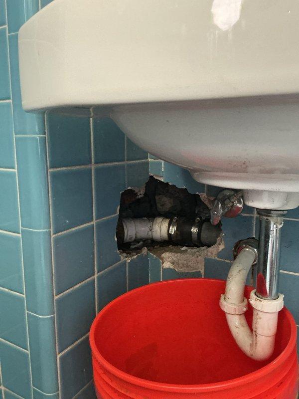 Responded to commercial plumbing service call regarding a baptismal pool heating issue. Upon inspection, accessed plumbing connections behind wall-mounted sinks in tiled bathroom facility to diagnose heating system malfunction. Performed drain cleaning and maintenance procedures using professional auger equipment on dual sink configuration. Exposed wall cavity to access baptismal pool supply lines and heating connections, identified and resolved circulation issues affecting water temperature control. Completed necessary repairs to restore proper heating function to baptismal pool plumbing system.