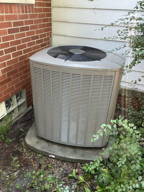 Completed Gold AC inspection on single residential unit with air handler located in basement. System is operational with homeowner reporting upstairs area warmer than downstairs during operation. Performed comprehensive inspection of outdoor condenser unit positioned on concrete pad against exterior wall, verified fan operation and examined overall equipment condition. Inspected associated water heater in basement, documented model specifications and control settings. Equipment is brand new 2025 model showing no signs of wear or operational deficiencies. All components functioning within normal parameters at time of inspection.