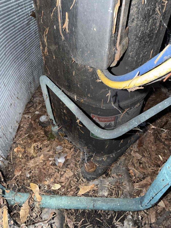 Responded to no cooling complaint on 10+ year old residential air conditioning system with basement evaporator coil location. Upon inspection, discovered severely cracked and deteriorated evaporator coil with visible structural damage and rust staining along fracture lines, indicating refrigerant leak and complete coil failure. Documented coil damage using inspection camera equipment. External examination of outdoor condensing unit revealed significant weathering with peeling exterior coating, debris accumulation around base, and exposed refrigerant lines with damaged insulation. Unit showed signs of extended outdoor exposure and lack of maintenance. Advised homeowner that evaporator coil replacement is required to restore cooling function, and recommended full system evaluation given age of equipment and deteriorated condition of both indoor and outdoor components.