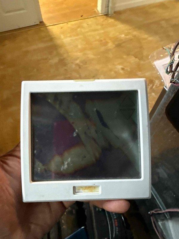 Responded to service call for 14-year-old Pro1 model T955W thermostat with failed LCD display located in foyer near front entrance. Upon arrival, confirmed thermostat screen was completely non-functional while unit remained powered. Inspected existing thermostat, documented current installation with photos showing wiring configuration and mounting location. Assessed compatibility for direct replacement versus upgrade options. Provided homeowner with recommendation for replacement unit due to age of existing equipment and availability of updated models with improved features and reliability.