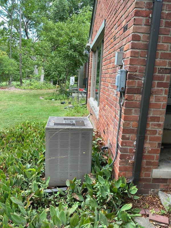 Provided comprehensive replacement estimate for 40+ year old residential air conditioning system currently operational but nearing end of service life. Evaluated existing outdoor condenser unit positioned on concrete pad against brick exterior, assessed indoor furnace and evaporator coil configuration located in dedicated equipment room with outside-only access, and confirmed natural gas fuel source for heating system. Documented equipment specifications, measured installation space constraints, verified electrical service capacity, and photographed current system layout to develop accurate replacement proposal for complete HVAC system upgrade.
