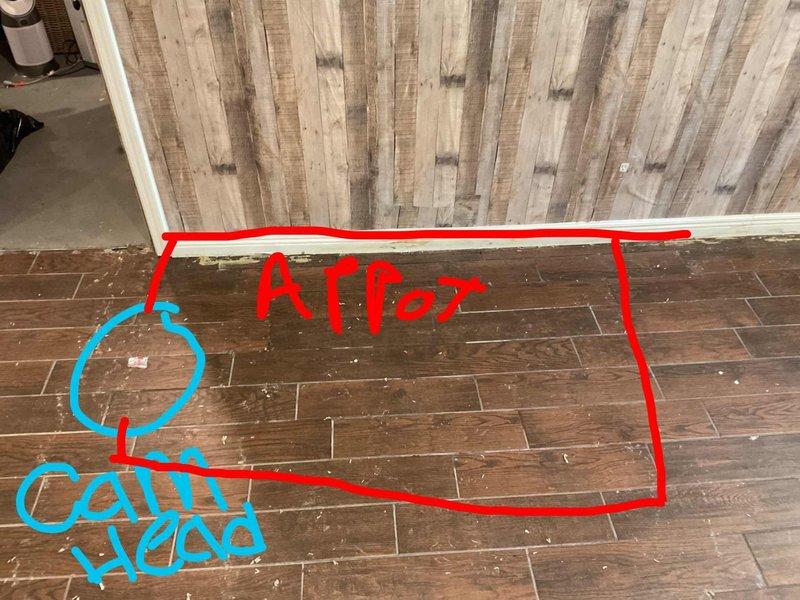 Responded to water leak in basement where carpet had been previously removed. Inspected affected area and flooring, documented damage to wood-look tile flooring and surrounding surfaces. Marked and assessed compromised flooring sections to determine extent of water intrusion and necessary remediation.