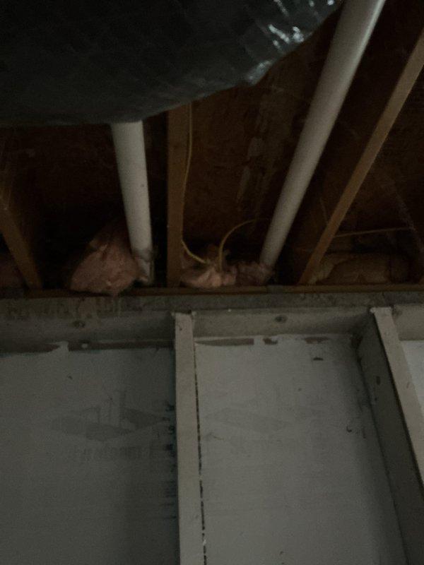 Conducted comprehensive assessment of natural gas heating system in basement of small residential property (0-1500 sq.ft.) to provide replacement estimate. Evaluated existing furnace unit, ductwork configuration including vertical rectangular metal supply duct with visible seams and connections, and associated components including PVC condensate drainage system. Documented current equipment condition, air flow specifications (16x20x1 filter size), electrical panel location, and existing HVAC infrastructure through detailed photographic documentation of mechanical room and upper-level structural spaces to determine optimal replacement unit specifications and installation requirements.