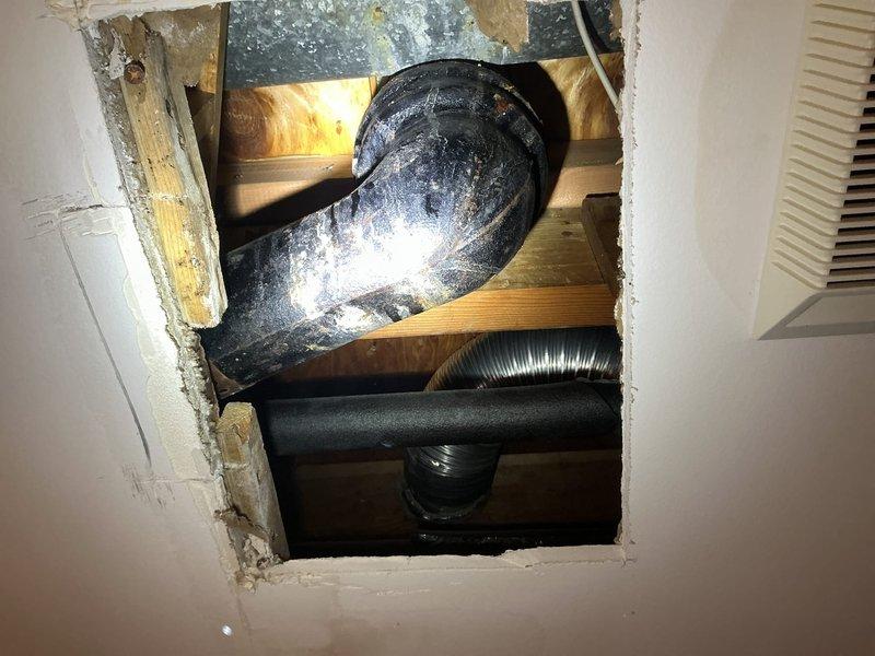 Responded to report of water leak from ceiling suspected to originate from upstairs bathroom. Upon investigation, accessed ceiling cavity and identified source of moisture intrusion related to plumbing fixture above. Inspected upstairs bathroom shower area and drain assembly, noting significant rust and corrosion on drain fixture and evidence of water damage on tile surfaces. Documented conditions via photography for assessment and provided recommendations for necessary repairs to resolve leak and prevent further ceiling damage.