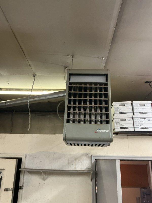 Performed comprehensive inspection of two commercial furnace units at the facility—one ceiling-mounted Modine unit in the warehouse area and one vertical cabinet-style unit in the office space. Conducted thorough visual examination of both heating systems, checking for proper operation, physical condition, and potential safety concerns. Documented equipment condition with photos for maintenance records.
