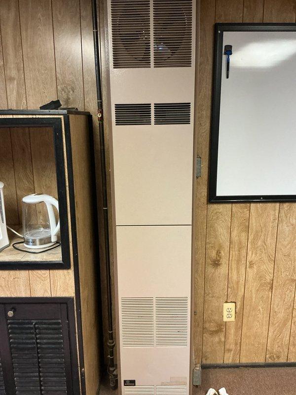 Performed comprehensive inspection of two commercial furnace units at the facility—one ceiling-mounted Modine unit in the warehouse area and one vertical cabinet-style unit in the office space. Conducted thorough visual examination of both heating systems, checking for proper operation, physical condition, and potential safety concerns. Documented equipment condition with photos for maintenance records.