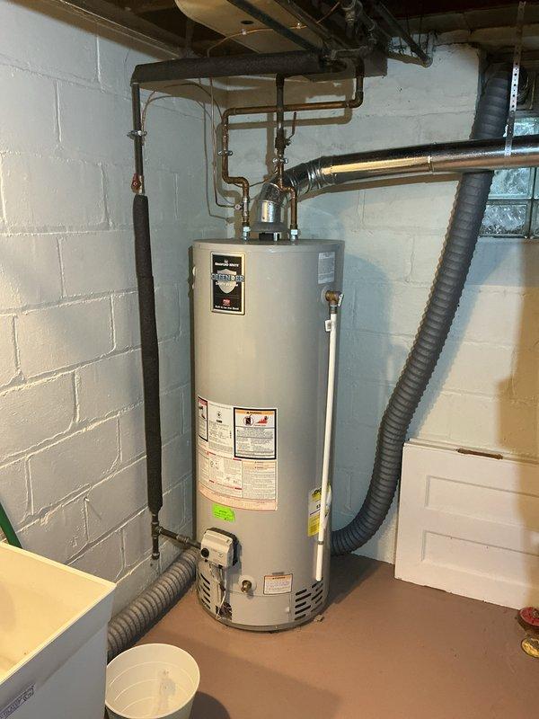 Completed comprehensive Gold AC Inspection on an 8-year-old residential air conditioning system with air handler located in basement utility room. System was operational at time of inspection with thermostat displaying 74°F and functioning properly. Performed standard maintenance procedures including visual inspection of equipment, verification of proper refrigerant levels, assessment of electrical connections, examination of condensate drainage system, and evaluation of overall system performance and efficiency.