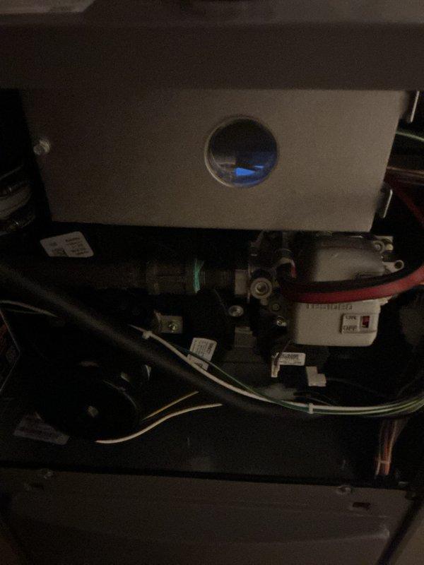Completed scheduled maintenance on a 1-year-old residential furnace located in the basement. Performed comprehensive system inspection including verification of burner operation with blue flame combustion visible through observation port. Inspected all internal components, gas valves, piping connections, electrical wiring, and safety controls for proper operation. Evaluated and documented condition of air filter showing accumulated debris; filter replacement recommended to maintain optimal airflow and system efficiency. All mechanical components, including expansion vessel and control wiring, found to be functioning within normal parameters. System operational and heating properly upon completion of maintenance service.