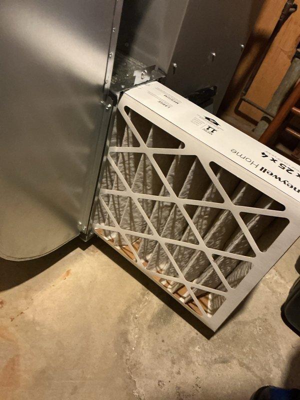Completed scheduled maintenance on a 1-year-old residential furnace located in the basement. Performed comprehensive system inspection including verification of burner operation with blue flame combustion visible through observation port. Inspected all internal components, gas valves, piping connections, electrical wiring, and safety controls for proper operation. Evaluated and documented condition of air filter showing accumulated debris; filter replacement recommended to maintain optimal airflow and system efficiency. All mechanical components, including expansion vessel and control wiring, found to be functioning within normal parameters. System operational and heating properly upon completion of maintenance service.