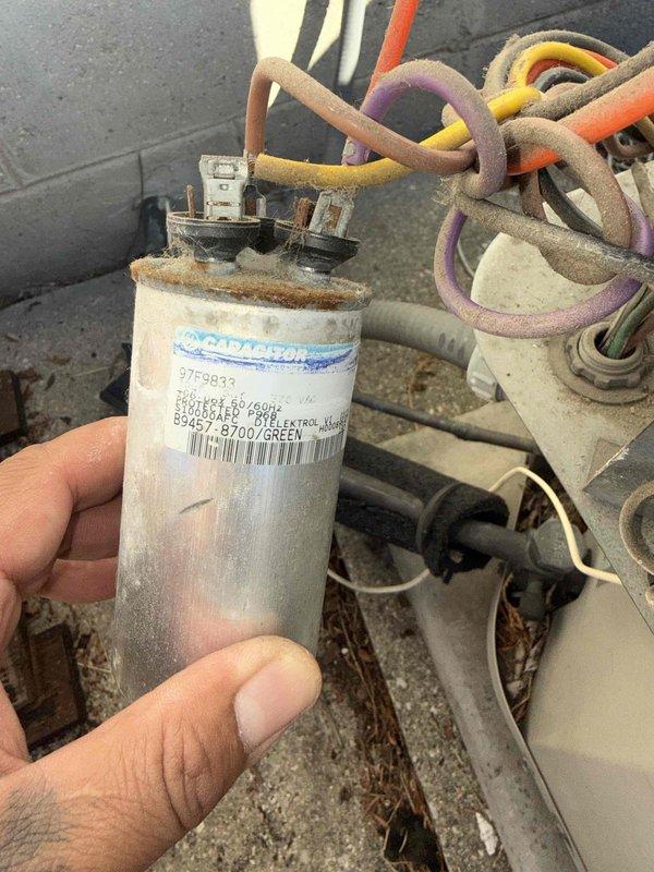 Responded to no-cooling complaint at rental property where tenant reported unusual fan noise and complete loss of cooling capacity. Upon inspection, identified failed run capacitor with severe corrosion and oxidation on terminals. Replaced defective capacitor with new unit, verified all electrical connections, and tested system operation. Unit now running properly with normal fan operation and adequate cooling restored.