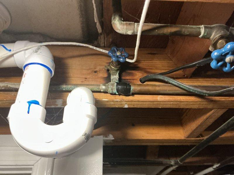 Responded to a water leak in the basement. Upon inspection, identified leaking at the P-trap assembly beneath a sink fixture. Replaced the deteriorated white PVC P-trap and associated drain connections. Verified proper seal at all connection points, tested the drain system for leaks, and confirmed the repair eliminated the water intrusion issue.
