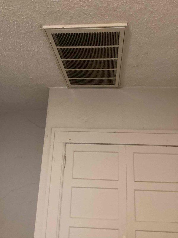 Conducted estimate for replacement of 10+ year old Spacepack system with attic-mounted natural gas furnace. Current equipment operational but aging, with visible dust accumulation on interior vent grilles and flexible ductwork in attic space. Documented existing installation including flexible duct routing, insulation condition, and equipment accessibility for replacement planning.