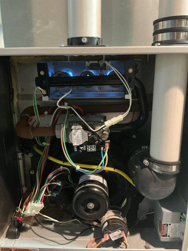Completed comprehensive Gold AC inspection on 10-year-old residential cooling system with air handler located in basement and condensing unit positioned on exterior. Performed thorough examination of indoor unit components including blower motors, electrical connections, wiring harness, PVC condensate drainage lines, and internal mechanical assemblies, confirming all components operating within normal parameters. Inspected outdoor condensing unit including fan motor assembly, protective grille, refrigerant line sets with insulation, and copper piping connections, verifying proper system operation and structural integrity of all equipment.