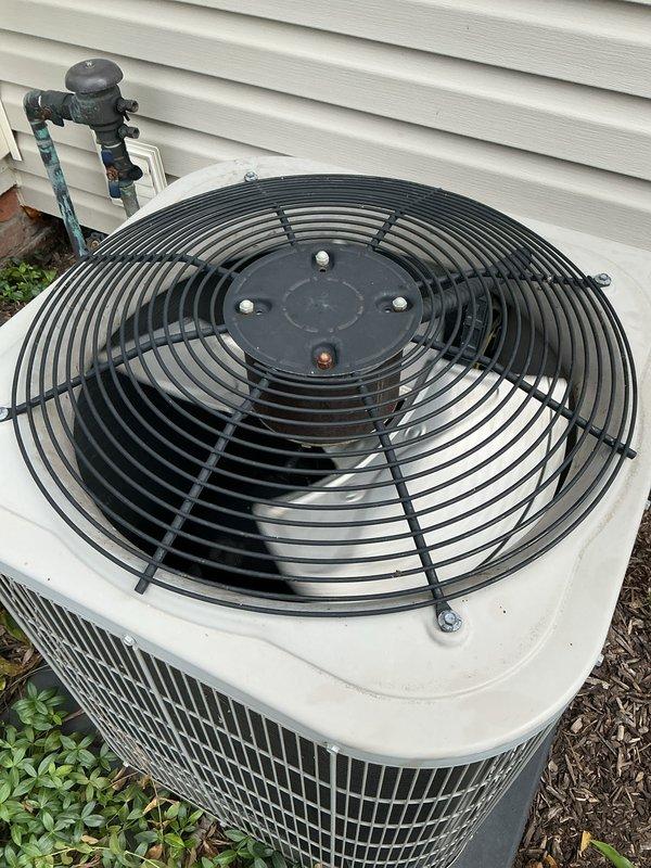 Completed comprehensive Gold AC inspection on 10-year-old residential cooling system with air handler located in basement and condensing unit positioned on exterior. Performed thorough examination of indoor unit components including blower motors, electrical connections, wiring harness, PVC condensate drainage lines, and internal mechanical assemblies, confirming all components operating within normal parameters. Inspected outdoor condensing unit including fan motor assembly, protective grille, refrigerant line sets with insulation, and copper piping connections, verifying proper system operation and structural integrity of all equipment.