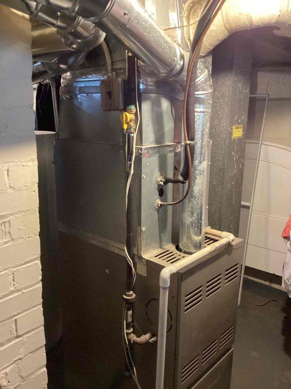 Responded to service call for central air conditioning system not cooling and fan making excessive noise. Upon inspection of basement HVAC equipment, assessed existing air handler, furnace, and associated ductwork system. Provided comprehensive replacement estimate for complete HVAC system upgrade due to equipment age and operational failure, including new air handler unit, refrigerant lines, and necessary connections to existing infrastructure.