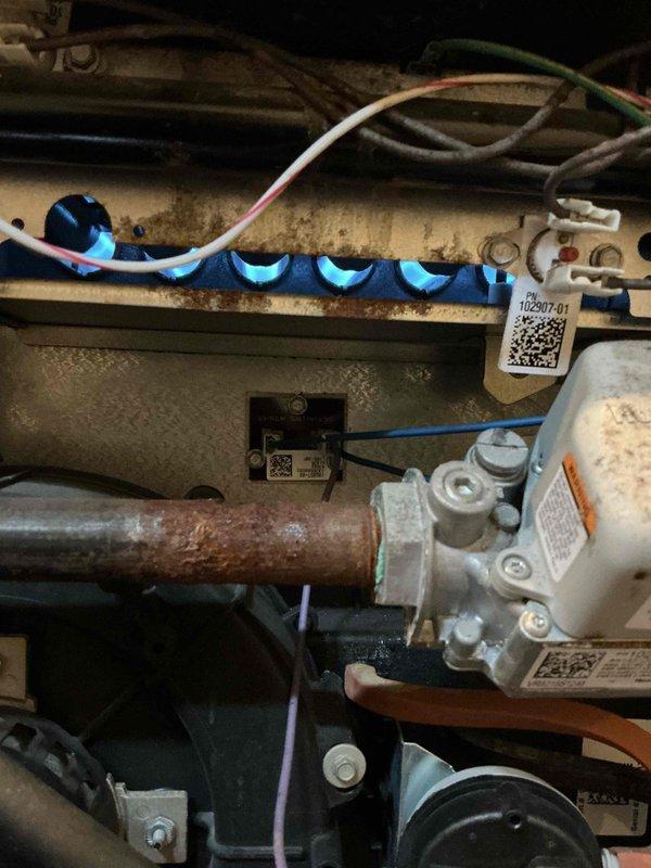 Completed scheduled furnace maintenance on 2012 unit located in basement. Performed comprehensive inspection of gas valve assembly, ignition components, blower motor, and all electrical connections. Noted moderate surface corrosion on copper piping and rust accumulation on mounting rails and metal framework consistent with equipment age. All burner components, gas control valve, and flame sensor coil inspected and found operational. Verified proper wire connections throughout system and checked blower assembly function. Unit operating within normal parameters at time of service completion.