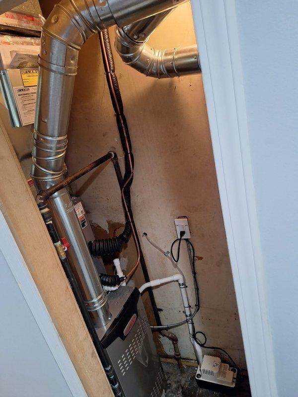 Completed full HVAC system installation including a 70,000 BTU furnace and 2.5-ton air conditioning unit in left-side utility closet configuration. Performed system flush, installed condensate pump, reconnected electrical service, and installed 16x25x1 filter. Mechanical and electrical permits were obtained prior to installation, and all ductwork connections were secured and sealed to manufacturer specifications.