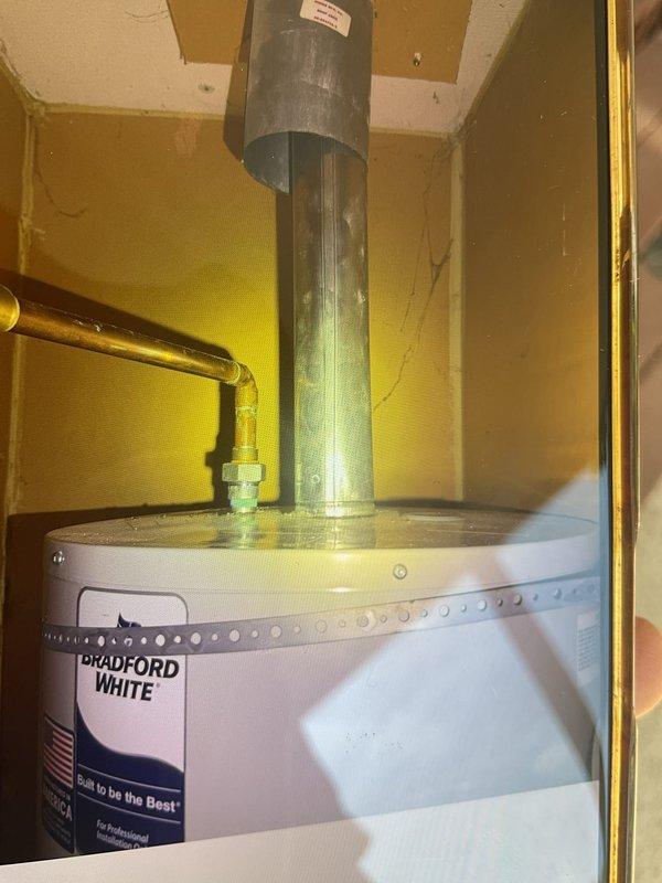 Responded to warranty call for 3-month-old Bradford White water heater with pilot light failure located in bedroom closet. Upon inspection, discovered damaged thermopile wiring with exposed conductors in gas control compartment, preventing proper flame sensing and causing pilot safety lockout. Replaced faulty thermopile assembly, cleaned accumulated debris from burner compartment and gas valve area, verified proper pilot flame characteristics, and tested unit through multiple heating cycles to confirm reliable ignition and operation.
