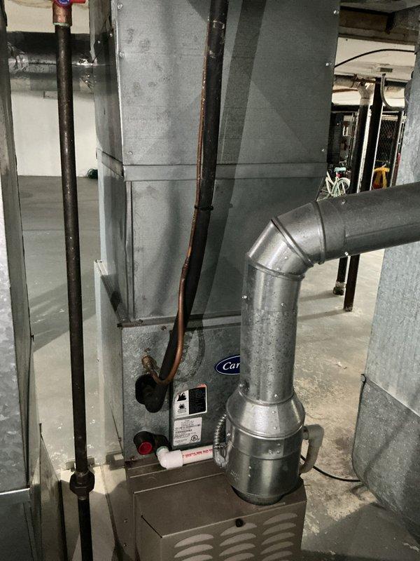 Conducted comprehensive assessment of existing HVAC system for full replacement estimate. Evaluated current vertical air handler unit in basement mechanical room, including associated ductwork, copper refrigerant lines, and condensate drainage. Inspected existing Honeywell thermostat displaying 73 degrees to assess compatibility requirements for new equipment installation. Documented equipment specifications, spatial constraints, and existing infrastructure to provide accurate proposal for complete air conditioning and furnace system replacement.