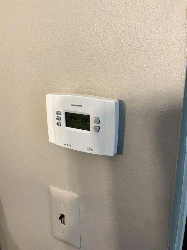 Conducted comprehensive assessment of existing HVAC system for full replacement estimate. Evaluated current vertical air handler unit in basement mechanical room, including associated ductwork, copper refrigerant lines, and condensate drainage. Inspected existing Honeywell thermostat displaying 73 degrees to assess compatibility requirements for new equipment installation. Documented equipment specifications, spatial constraints, and existing infrastructure to provide accurate proposal for complete air conditioning and furnace system replacement.