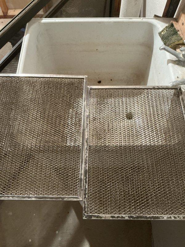 Completed comprehensive furnace inspection and tune-up on 16-year-old unit located in basement storage room. Removed and cleaned heavily soiled aluminum mesh filters showing significant grease and dust accumulation, restoring proper airflow. Inspected evaporative cooler assembly in attic space, noting considerable mineral deposits and debris buildup on honeycomb cooling pad. Verified motor assembly, electrical connections, and ductwork connections for proper operation. System operational upon completion with improved air filtration efficiency.