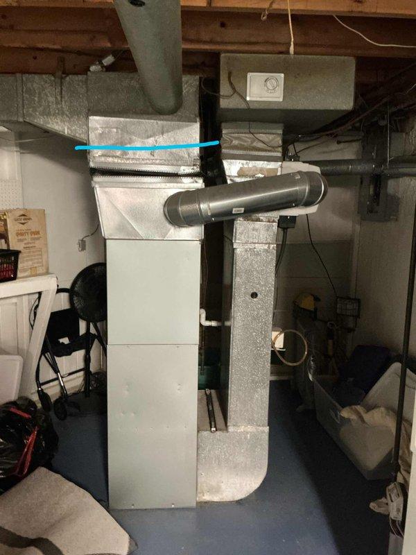 Conducted comprehensive assessment of existing HVAC system for full replacement estimate, including 17-year-old air conditioning unit located outside, furnace of unknown age in basement, and mini split system. Evaluated current installation configuration, including furnace unit with associated ductwork transitions, metal plenum connections, and vertical/horizontal duct runs throughout basement utility area. Documented existing equipment conditions, electrical connections, control systems, and overall system layout through photographic inspection to provide accurate replacement recommendations for complete heating and cooling system upgrade.