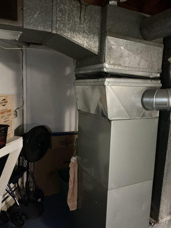 Conducted comprehensive assessment of existing HVAC system for full replacement estimate, including 17-year-old air conditioning unit located outside, furnace of unknown age in basement, and mini split system. Evaluated current installation configuration, including furnace unit with associated ductwork transitions, metal plenum connections, and vertical/horizontal duct runs throughout basement utility area. Documented existing equipment conditions, electrical connections, control systems, and overall system layout through photographic inspection to provide accurate replacement recommendations for complete heating and cooling system upgrade.