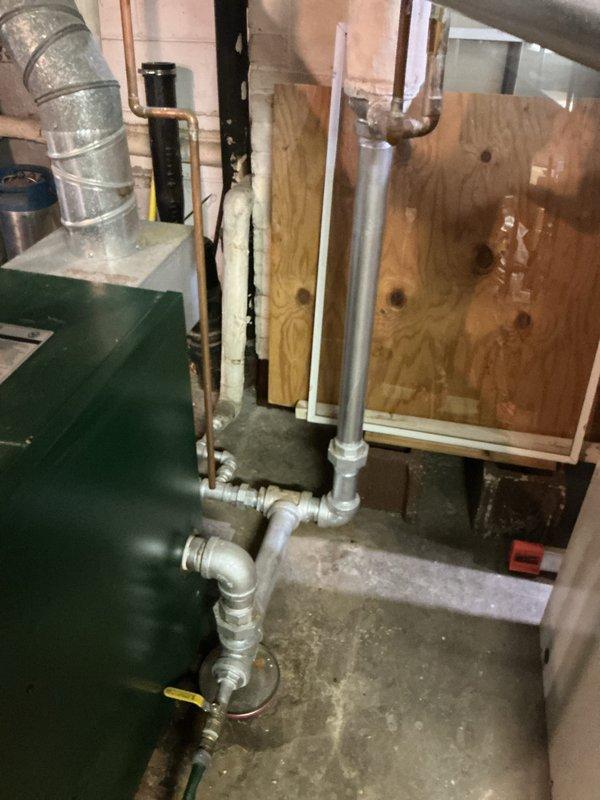 Conducted boiler replacement estimate for existing green metal unit with failed heat exchanger causing active water leak. Assessed hot water heating system with circulator pump and associated piping infrastructure in basement mechanical room. Documented current equipment condition and configuration to provide comprehensive replacement recommendations for failed boiler system.