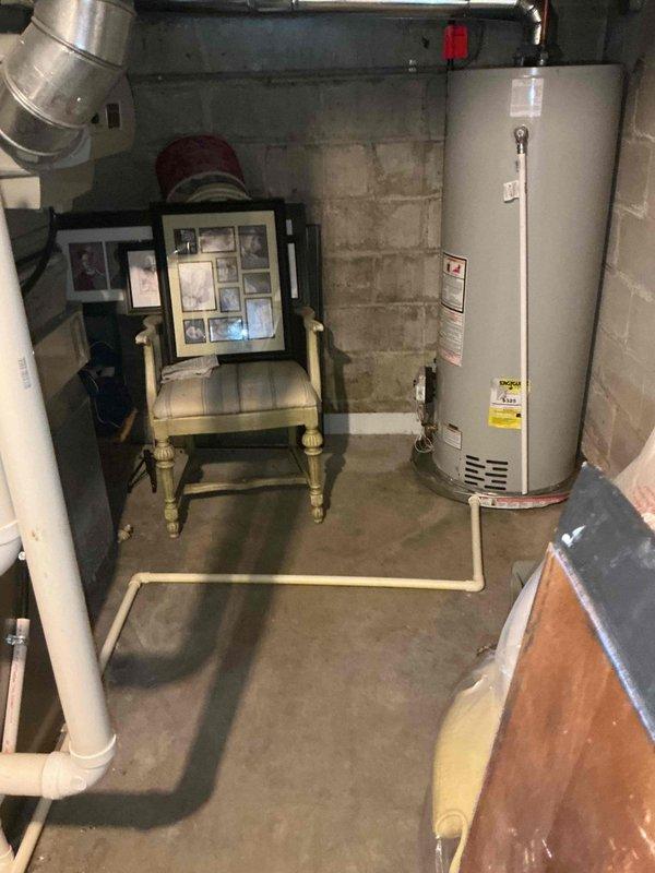 Responded to city code violation for water heater installation missing required drain pan. Installed compliant drip pan beneath water heater per 2024 municipal code requirements. Documented installation with photographs for inspector review and code compliance verification.