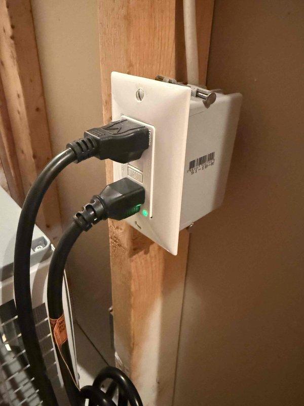 Returned to site to replace defective GFCI outlet. Removed existing GFCI receptacle from electrical box mounted in wall framing and installed new white GFCI outlet with proper wiring connections to copper conductors. Verified proper operation of test and reset functions, confirmed ground fault protection is working correctly, and tested both receptacles under load with connected devices showing normal operation with indicator lights functioning as designed.