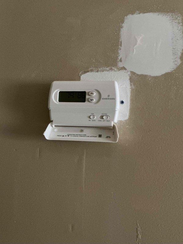 Completed installation of 70,000 BTU furnace with new PVC venting system routed through exterior wall. Installed additional gas line to accommodate water heater connection and performed electrical reconnection. Mounted and programmed new Emerson programmable thermostat with wall patching and finishing work at installation location. Submitted mechanical and electrical permit applications and registered system for utility rebate eligibility.